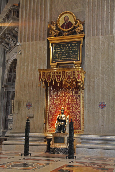 Saint Peters Chair in Saint Peters Basilica surmounted by medalion of Pope Pius IX